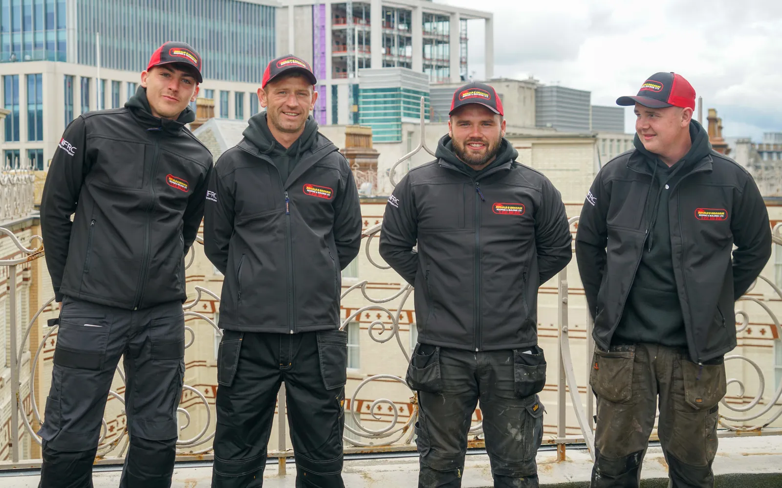 The Ronald G Graham team on the Midland Hotel roof, Manchester skyline behind